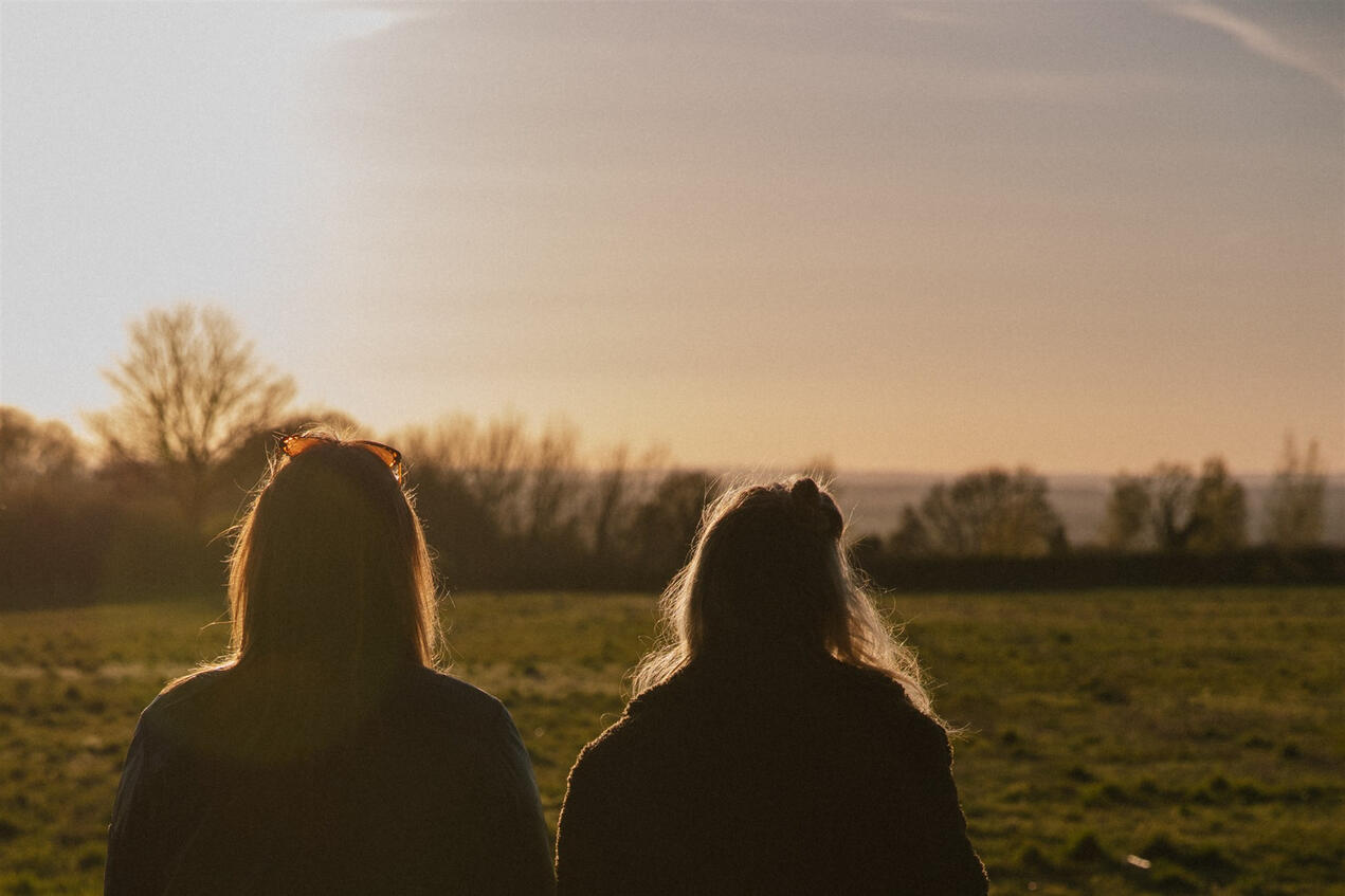 Two women sitting enjoying the view during their retreat stay.