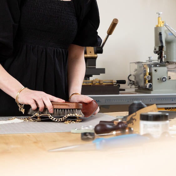 Branding photography of artisan leather maker in Lincolnshire studio, hands at work.