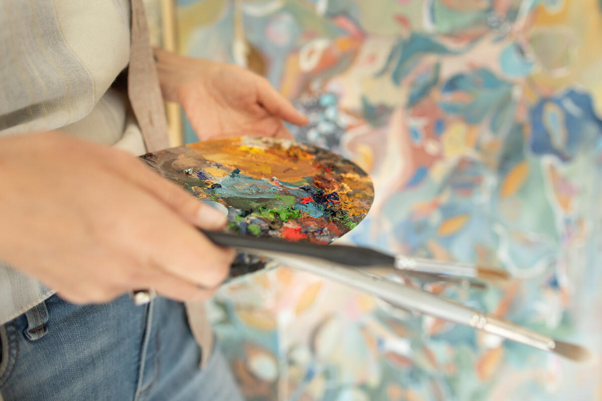 Close-up of artist’s paint palette during creative branding photoshoot.