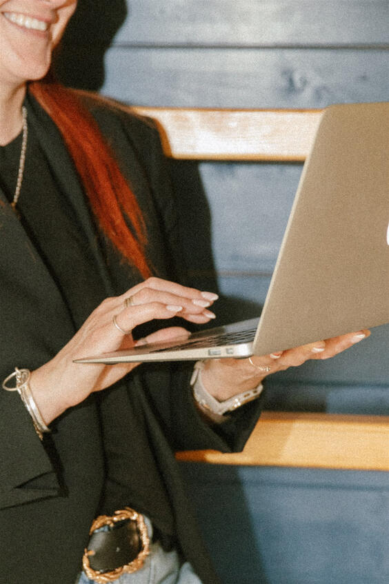 Close-up of hands on laptop during branding photoshoot.